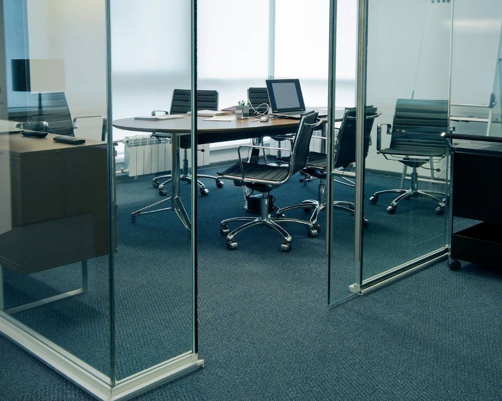 Computers sit on desk tops in a modern office.